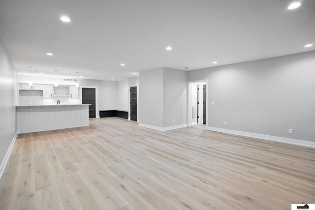 7949 Ponce Dr, Lincoln, NE 68516 - unfurnished living room with baseboards, light wood-style flooring, and recessed lighting