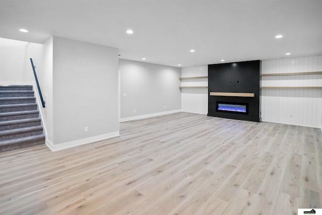 7949 Ponce Dr, Lincoln, NE 68516 - unfurnished living room with light wood-type flooring, stairway, recessed lighting, baseboards, and a fireplace