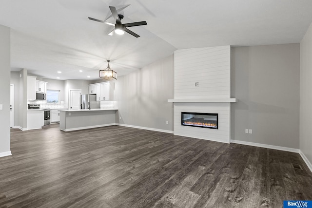 5948 Loxton St, Lincoln, NE 68526 - unfurnished living room with dark wood-type flooring, a fireplace, ceiling fan, recessed lighting, and baseboards