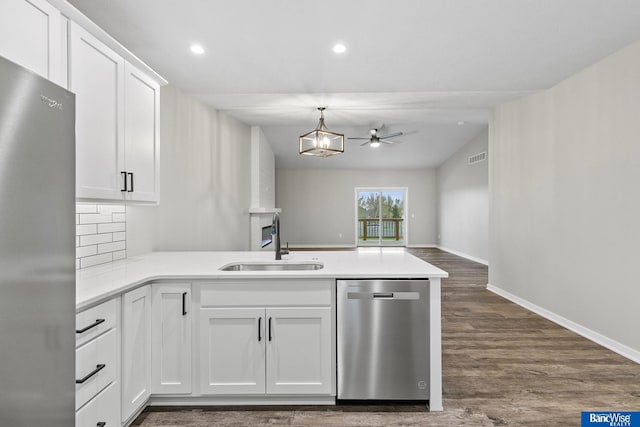 5948 Loxton St, Lincoln, NE 68526 - kitchen featuring appliances with stainless steel finishes, a sink, a peninsula, light countertops, and recessed lighting
