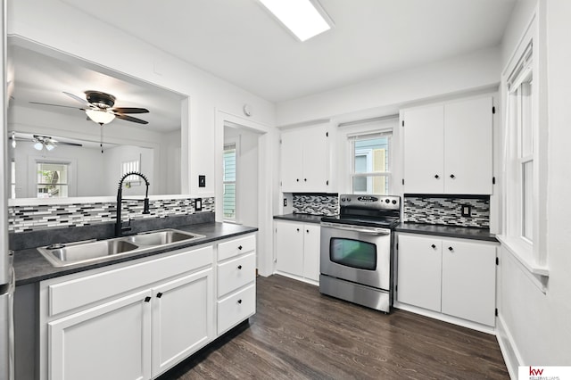 2740 N 49th St, Omaha, NE 68104 - kitchen featuring stainless steel electric stove, dark countertops, tasteful backsplash, and a sink