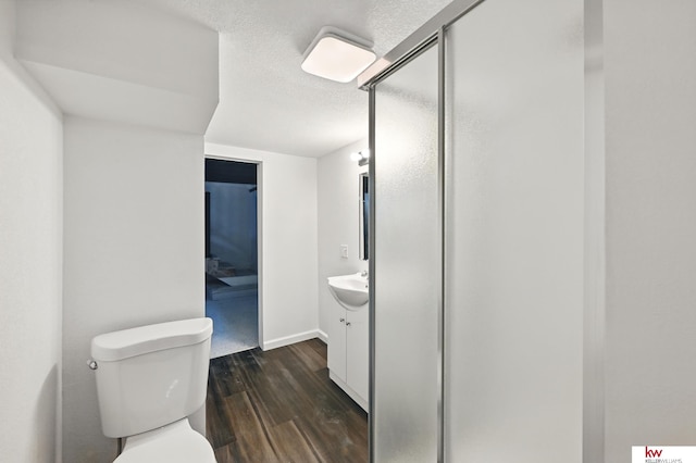 2740 N 49th St, Omaha, NE 68104 - bathroom featuring vanity, toilet, wood finished floors, a shower stall, and baseboards