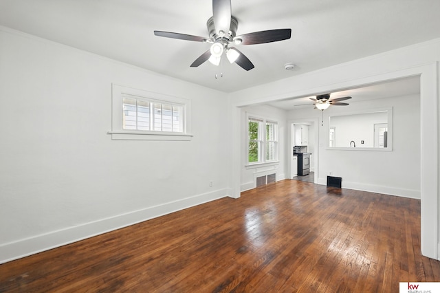 2740 N 49th St, Omaha, NE 68104 - unfurnished living room featuring ceiling fan, baseboards, and hardwood / wood-style floors