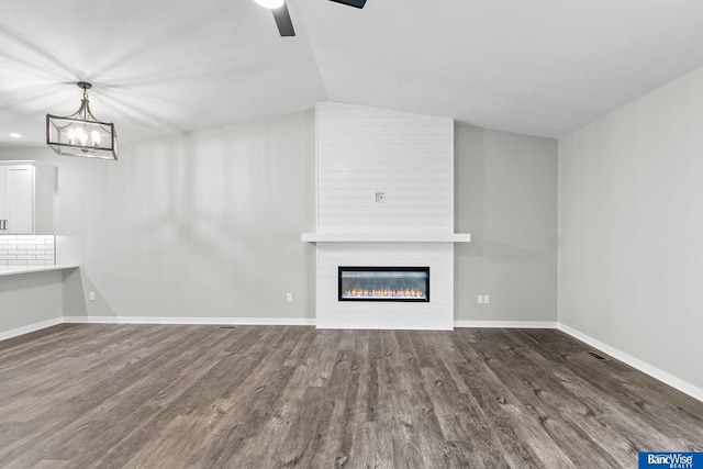 5956 Loxton St, Lincoln, NE 68526 - unfurnished living room with wood finished floors, a large fireplace, ceiling fan, baseboards, and vaulted ceiling