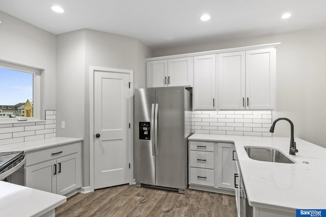 5956 Loxton St, Lincoln, NE 68526 - kitchen with stainless steel fridge with ice dispenser, a sink, light stone countertops, recessed lighting, and dark wood-type flooring