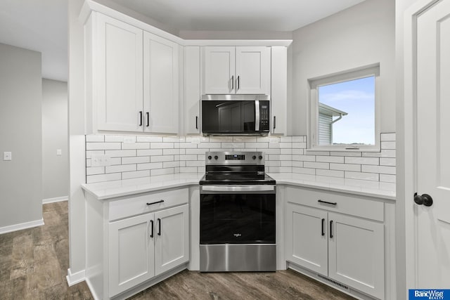 5956 Loxton St, Lincoln, NE 68526 - kitchen featuring appliances with stainless steel finishes, light countertops, dark wood-type flooring, and tasteful backsplash