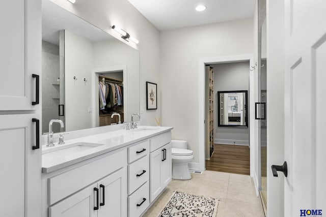 9750 Casa Galeano Ct, Lincoln, NE 68520 - full bath featuring toilet, double vanity, a stall shower, tile patterned floors, and a spacious closet