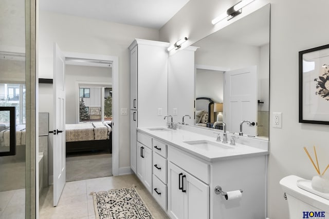 9750 Casa Galeano Ct, Lincoln, NE 68520 - ensuite bathroom featuring double vanity, toilet, baseboards, and tile patterned floors