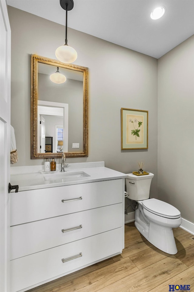 9750 Casa Galeano Ct, Lincoln, NE 68520 - half bathroom with toilet, wood finished floors, vanity, and baseboards