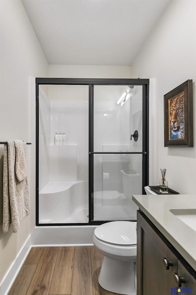 9750 Casa Galeano Ct, Lincoln, NE 68520 - full bathroom with wood finished floors, a stall shower, toilet, and vanity