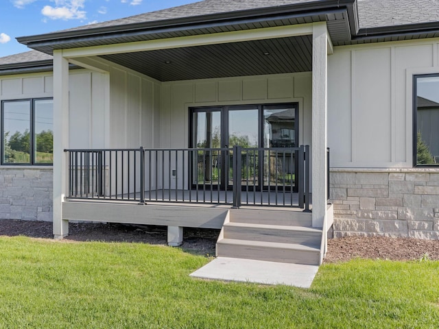 9750 Casa Galeano Ct, Lincoln, NE 68520 - entrance to property with a shingled roof, board and batten siding, stone siding, and a lawn