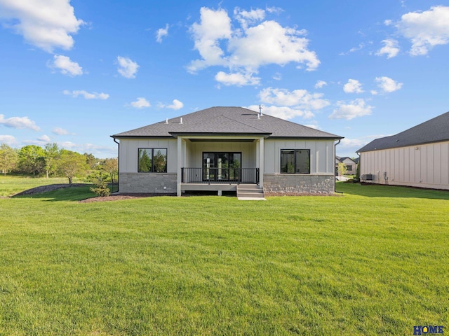 9750 Casa Galeano Ct, Lincoln, NE 68520 - rear view of house featuring stone siding, board and batten siding, and a yard