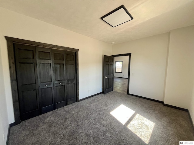 231 N Government St, Valentine, NE 69201 - unfurnished bedroom with carpet flooring, baseboards, and a closet