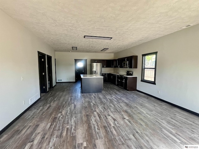 231 N Government St, Valentine, NE 69201 - kitchen featuring stainless steel appliances, dark wood-type flooring, a center island, baseboards, and light countertops