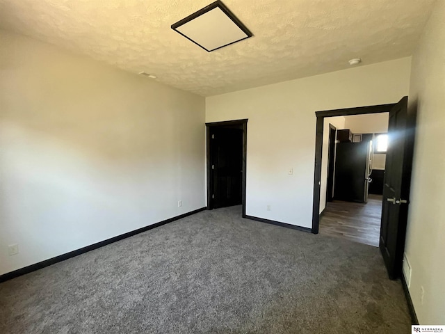 231 N Government St, Valentine, NE 69201 - unfurnished bedroom with carpet floors, baseboards, and a textured ceiling