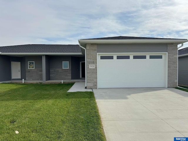9434 Duckhorn Dr, Lincoln, NE 68526 - view of front facade featuring stone siding, concrete driveway, a front yard, and an attached garage