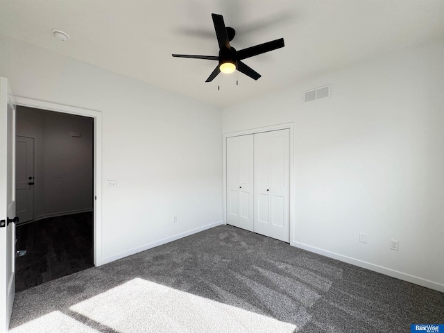 9434 Duckhorn Dr, Lincoln, NE 68526 - unfurnished bedroom featuring dark colored carpet, baseboards, a closet, and ceiling fan