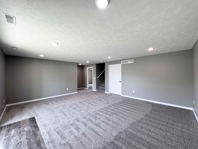 9434 Duckhorn Dr, Lincoln, NE 68526 - finished below grade area featuring a textured ceiling, baseboards, recessed lighting, and carpet floors