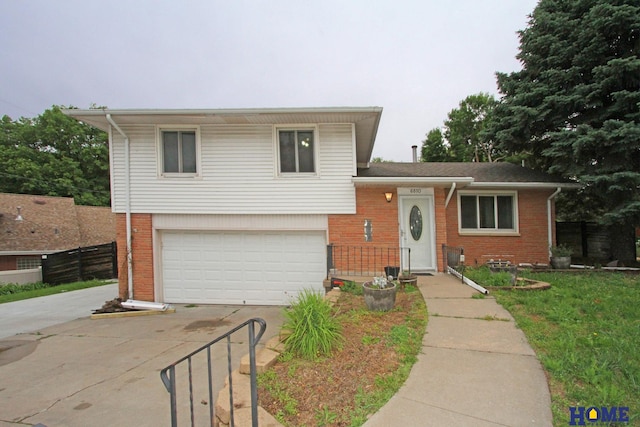 6810 S St S, Lincoln, NE 68506 - tri-level home featuring brick siding, driveway, and a garage