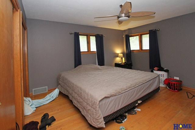 6810 S St S, Lincoln, NE 68506 - bedroom featuring multiple windows, light wood-type flooring, and baseboards