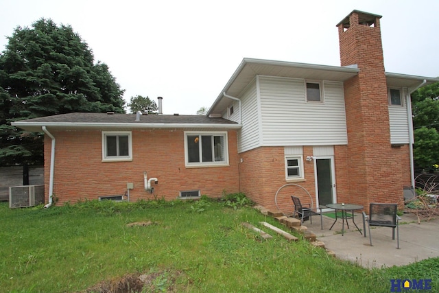 6810 S St S, Lincoln, NE 68506 - rear view of house with a chimney, a patio area, brick siding, and central air condition unit