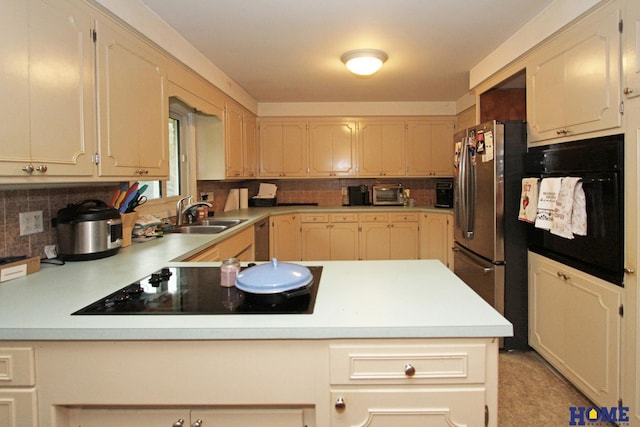 6810 S St S, Lincoln, NE 68506 - kitchen featuring black appliances, tasteful backsplash, a sink, and light countertops