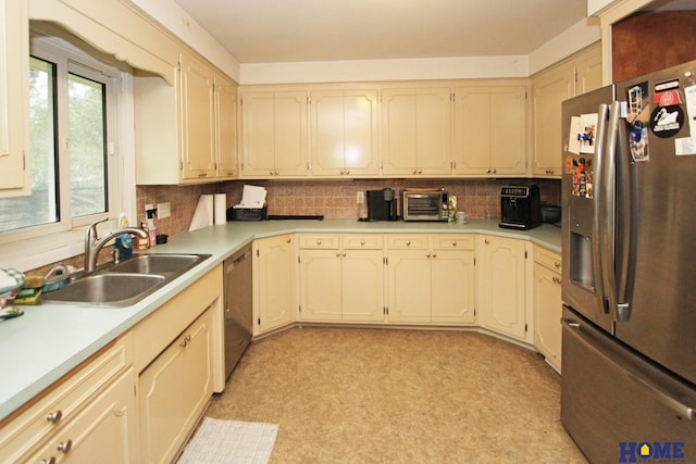 6810 S St S, Lincoln, NE 68506 - kitchen with stainless steel appliances, a sink, light floors, decorative backsplash, and light countertops