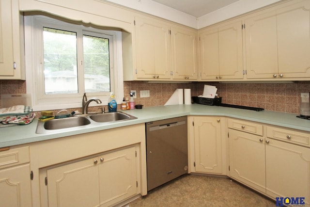 6810 S St S, Lincoln, NE 68506 - kitchen with stainless steel dishwasher, a sink, backsplash, light countertops, and cream cabinets