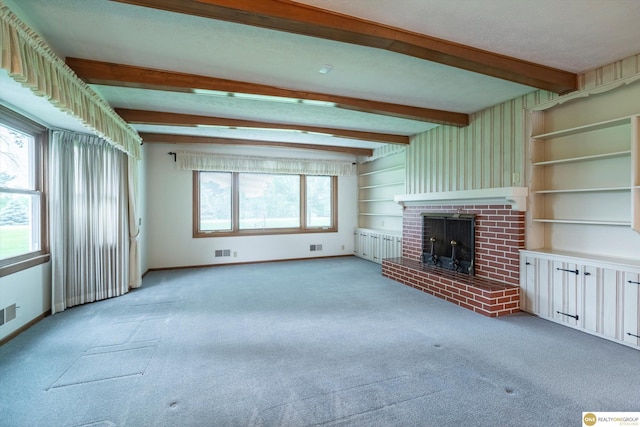 10919 N 69th St, Omaha, NE 68152 - unfurnished living room with radiator heating unit, light carpet, a fireplace, beam ceiling, and healthy amount of natural light