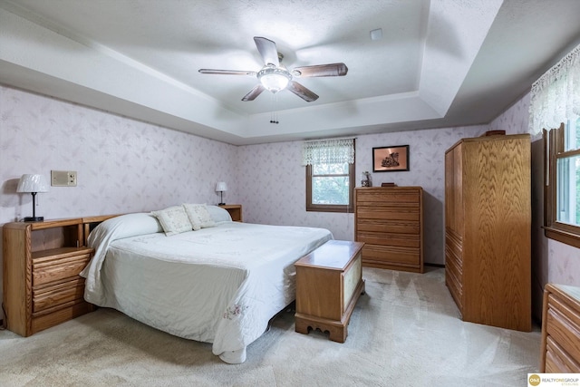 10919 N 69th St, Omaha, NE 68152 - bedroom with wallpapered walls, a raised ceiling, light colored carpet, and ceiling fan