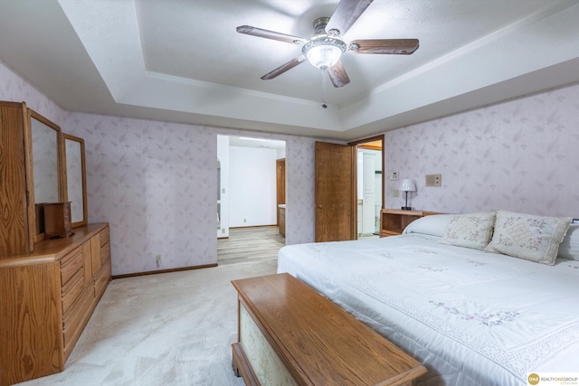 10919 N 69th St, Omaha, NE 68152 - bedroom featuring light carpet, a tray ceiling, wallpapered walls, and a ceiling fan