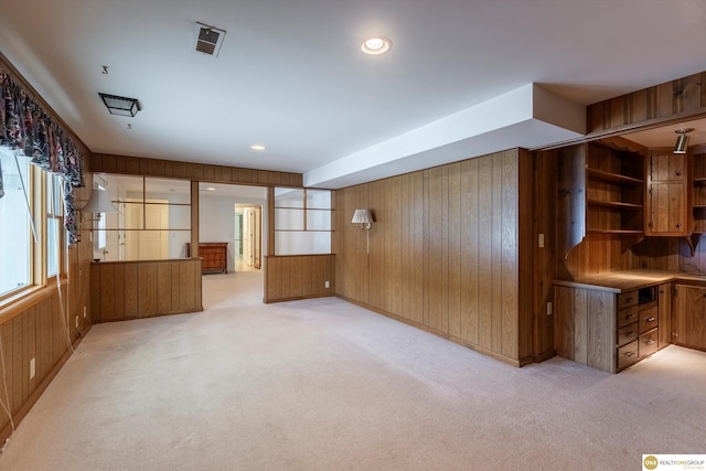 10919 N 69th St, Omaha, NE 68152 - spare room featuring wood walls and light carpet