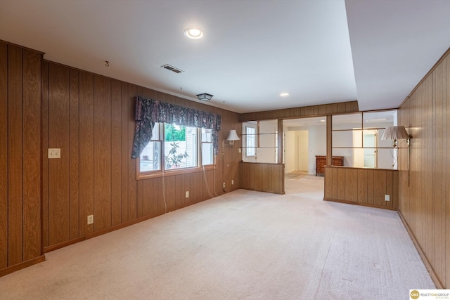 10919 N 69th St, Omaha, NE 68152 - spare room featuring wooden walls and light carpet