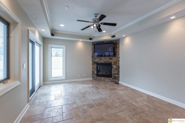 10919 N 69th St, Omaha, NE 68152 - unfurnished living room featuring crown molding, ceiling fan, a stone fireplace, stone tile flooring, and a raised ceiling