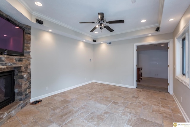 10919 N 69th St, Omaha, NE 68152 - empty room featuring light stone finish floors, a ceiling fan, crown molding, a stone fireplace, and baseboards