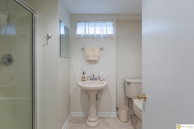 10919 N 69th St, Omaha, NE 68152 - bathroom with toilet, a shower stall, tile patterned floors, and baseboards