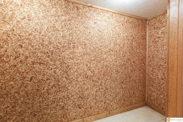 10919 N 69th St, Omaha, NE 68152 - empty room featuring tile patterned floors, baseboards, a textured ceiling, and crown molding