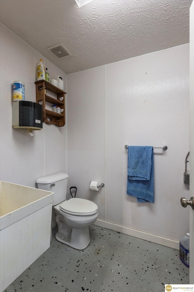 10919 N 69th St, Omaha, NE 68152 - half bath featuring toilet, baseboards, and a textured ceiling