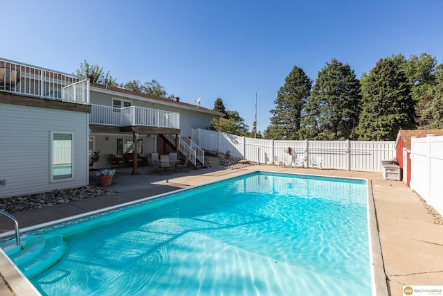 10919 N 69th St, Omaha, NE 68152 - view of swimming pool featuring stairway, a patio, a fenced backyard, and a wooden deck