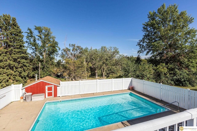 10919 N 69th St, Omaha, NE 68152 - view of swimming pool featuring a fenced backyard and a shed