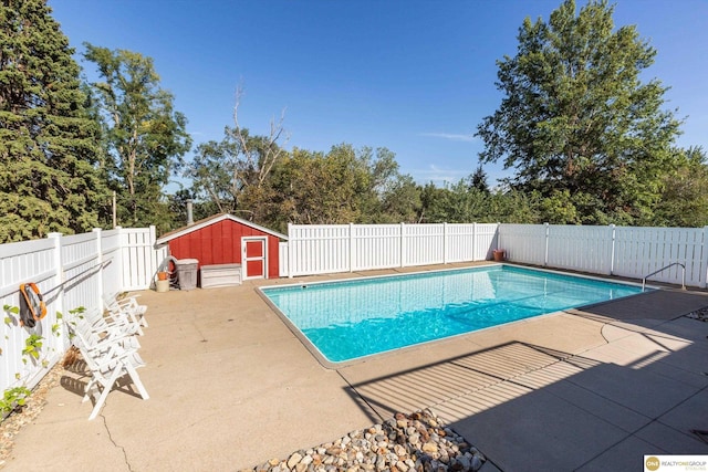 10919 N 69th St, Omaha, NE 68152 - view of swimming pool featuring a patio area, a fenced backyard, and view of wooded area