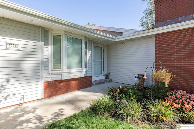 10919 N 69th St, Omaha, NE 68152 - property entrance with a chimney and brick siding