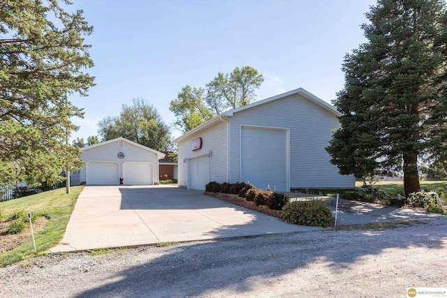 10919 N 69th St, Omaha, NE 68152 - view of side of property with a garage and an outbuilding