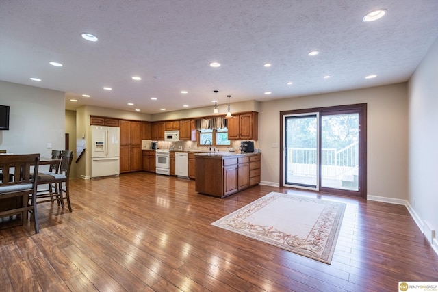10919 N 69th St, Omaha, NE 68152 - kitchen with white appliances, brown cabinets, recessed lighting, dark wood-style flooring, and baseboards