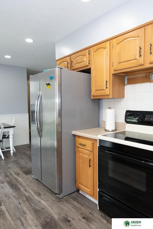 6 N Circle Dr, York, NE 68467 - kitchen featuring black electric range oven, stainless steel fridge with ice dispenser, dark wood finished floors, light countertops, and recessed lighting