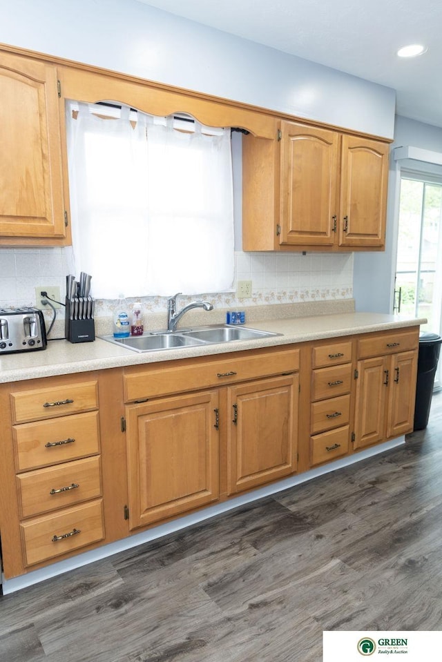 6 N Circle Dr, York, NE 68467 - kitchen featuring a sink, decorative backsplash, light countertops, dark wood-type flooring, and recessed lighting
