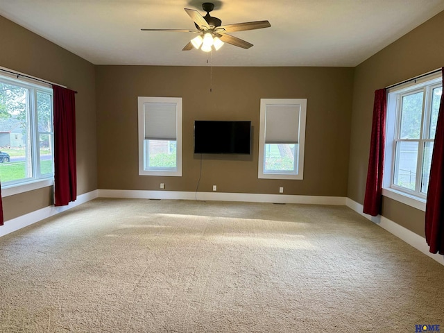 339 S Columbia Ave, Seward, NE 68434 - unfurnished room with light carpet, baseboards, and a ceiling fan