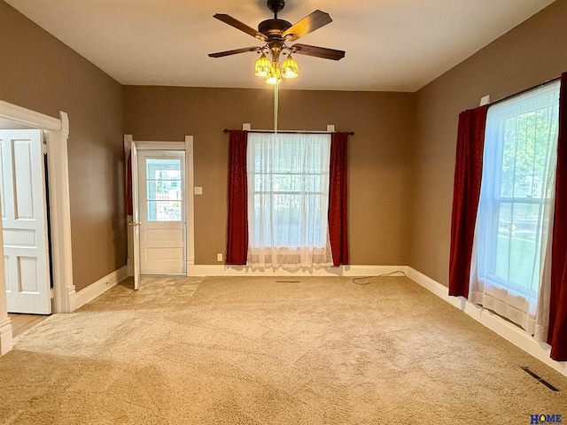 339 S Columbia Ave, Seward, NE 68434 - spare room with light colored carpet, a ceiling fan, and baseboards