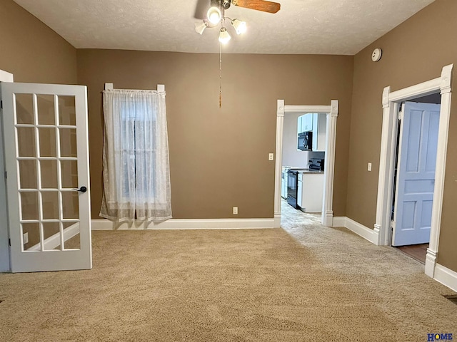 339 S Columbia Ave, Seward, NE 68434 - carpeted spare room featuring ceiling fan, a textured ceiling, and baseboards
