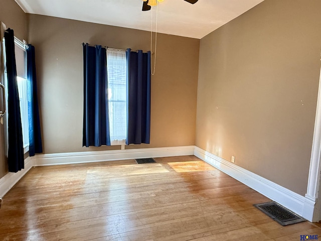 339 S Columbia Ave, Seward, NE 68434 - unfurnished room with ceiling fan, healthy amount of natural light, wood finished floors, and baseboards